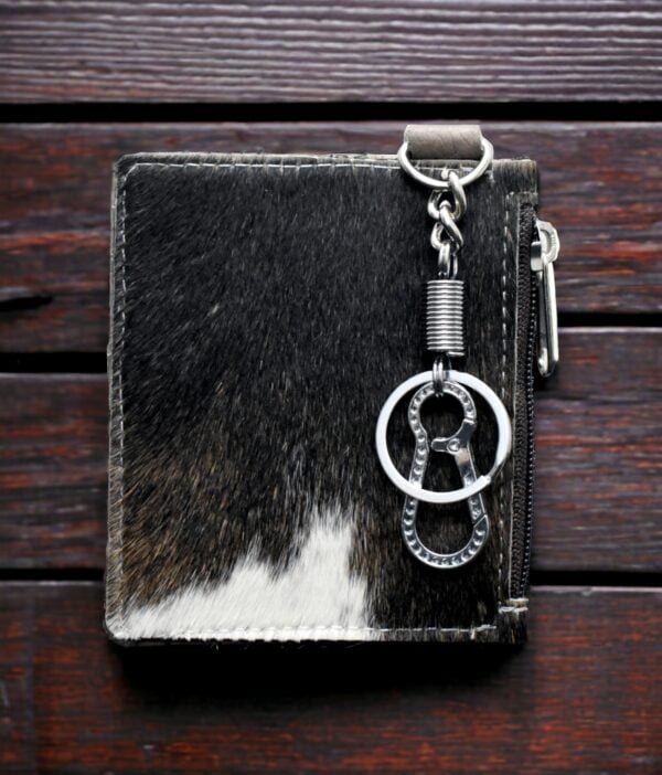 Close-up of brown leather keychain card holder with detailed stitching.