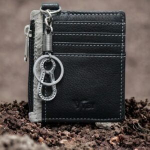 Close-up of brown leather keychain card holder with detailed stitching.