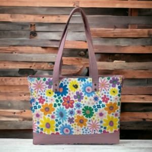 Model carrying the floral canvas tote bag with leather handles, perfect for everyday use.