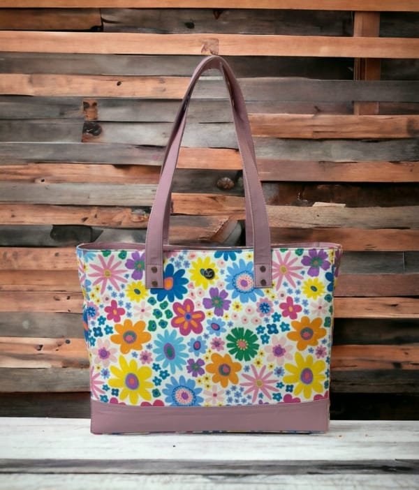 Model carrying the floral canvas tote bag with leather handles, perfect for everyday use.