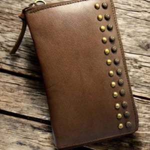 Tan genuine leather telephone clutch for women with front rivet design and adjustable sling handle